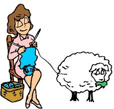 woman knitting from a sheep while sitting in a chair